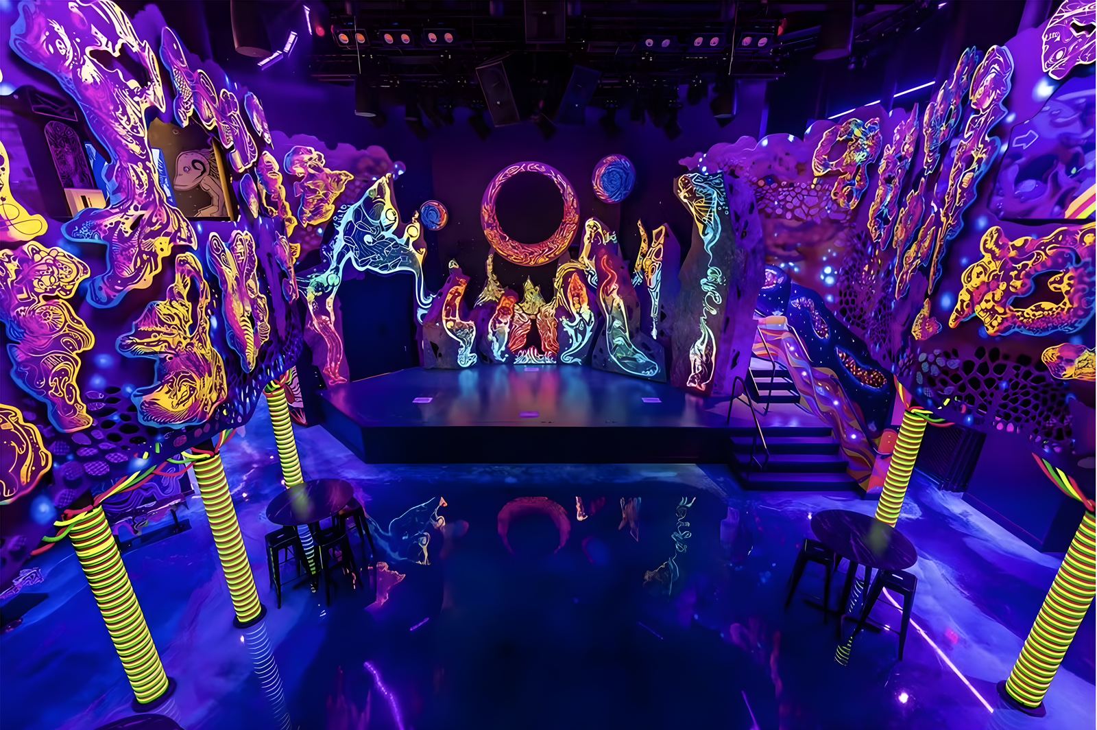 An immersive themed room glowing with fluorescent murals and sculpted forms.